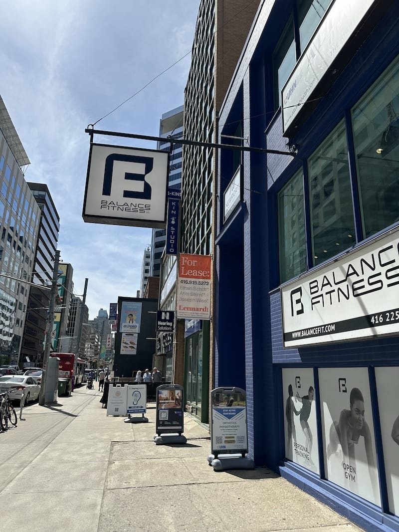 Exterior of Balance Fitness with glass facade and entrance off of St. Clair East in Toronto.